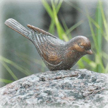 natuurlijke grafstenen bronzen vogeltje op zwerfkei