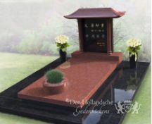 Chinees grafmonument met bloemen en plantenbak foto 1
