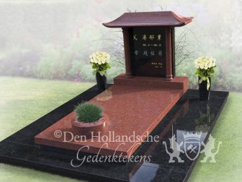 Chinees grafmonument met bloemen en plantenbak