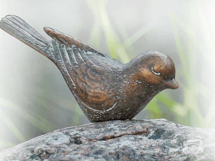 urnengraf-brons-vogeltje-zwerfkei.png foto 1