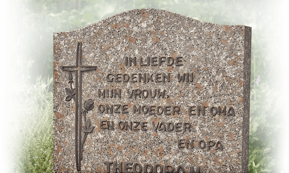 kruis brons op grafmonument van natuursteen